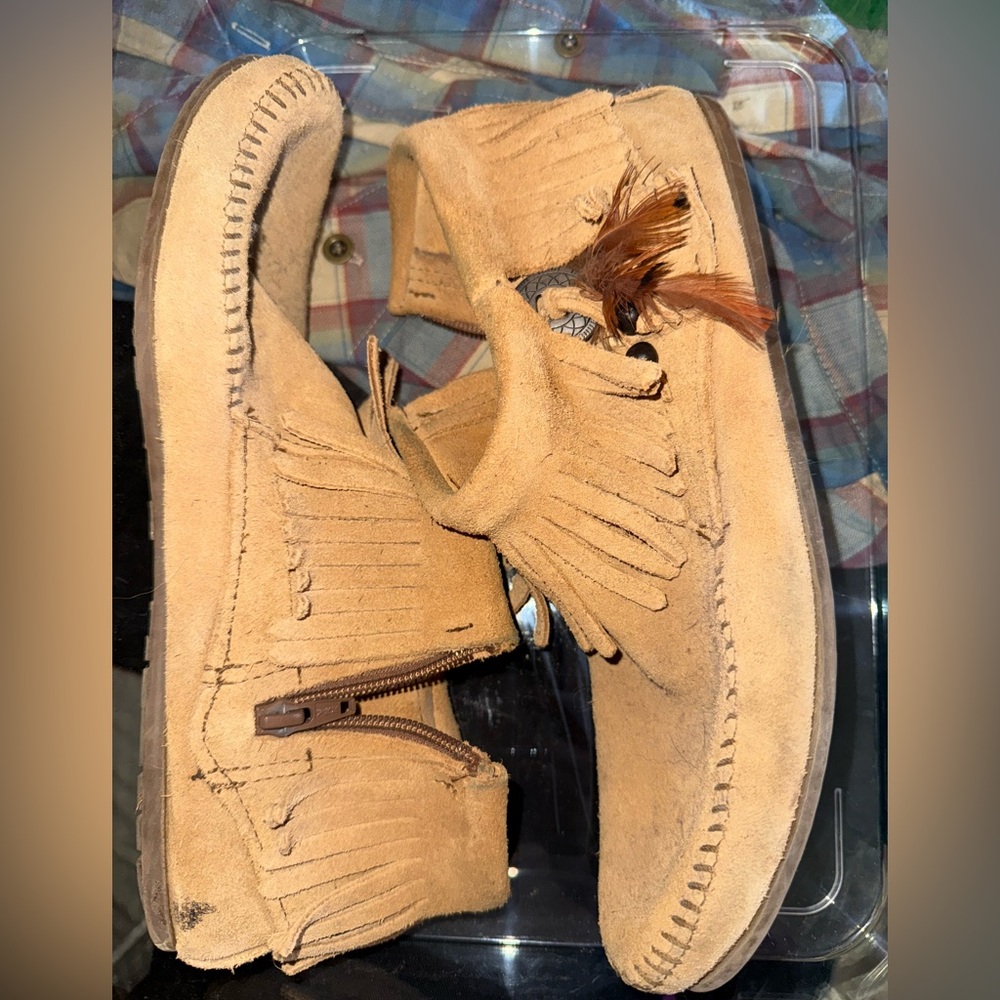 Ankle height Mocs with fringe and side zipper.